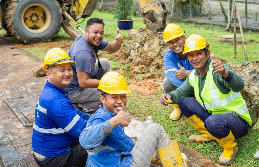 workers show their thumbs